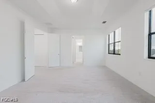a view of an empty room with windows