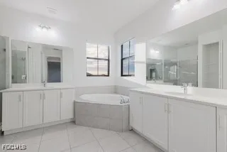 a bathroom with a tub sink and mirror