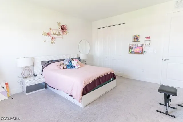 a bedroom with a bed and a chair