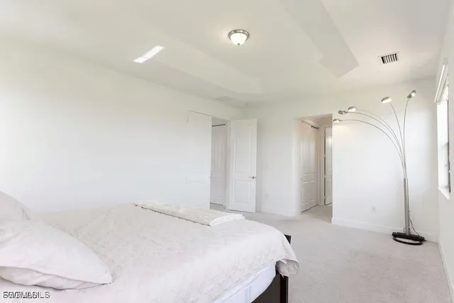 a bedroom with a bed and a mirror