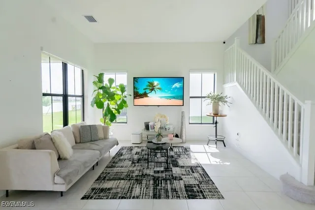 a living room with furniture fireplace and a large window
