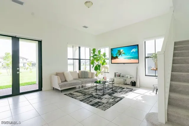 a living room with furniture and a large window