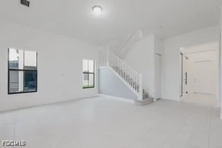 a view of an empty room with stairs