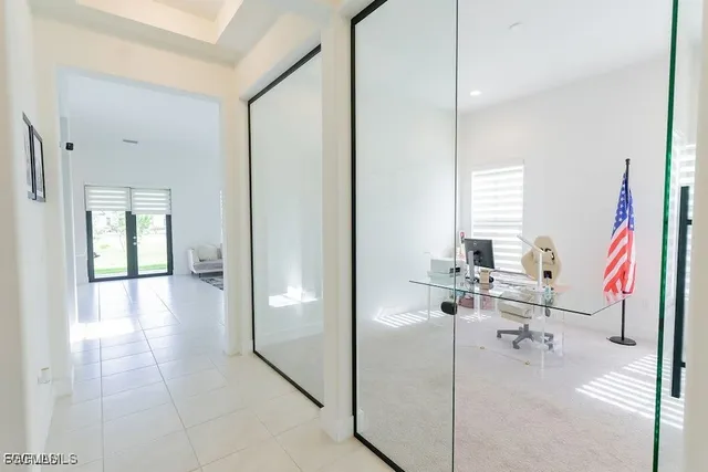 a view of a hallway with wooden floor and furniture