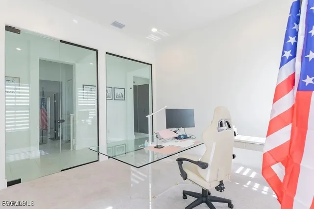 a view of a workspace with furniture and a fireplace