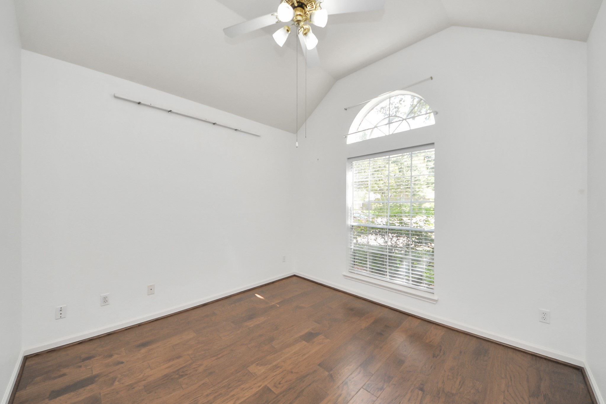 5815 Pheasant Ridge Lane Houston, TX 77041 - Photo 10 of 46 Bright room with vaulted ceiling, wood flooring, and a large window, perfect for natural light.