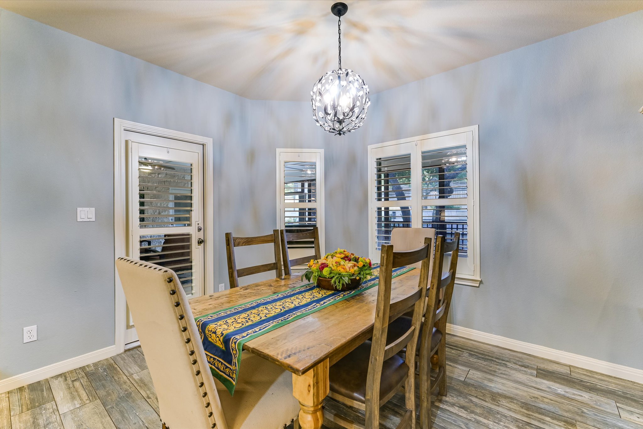 786 Ranchers Club Lane Driftwood, TX 78619 - Photo 11 of 33 Dining area with wood-type flooring and a chandelier