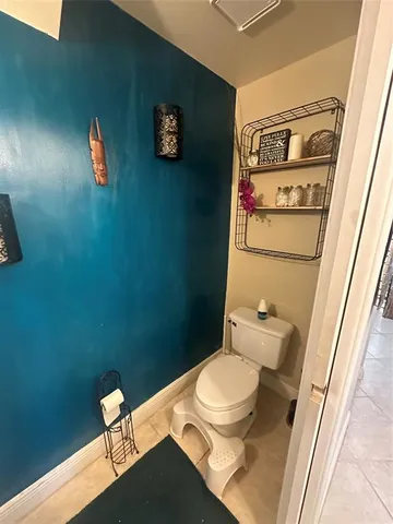 a bedroom with bed and a flat tv screen on dresser