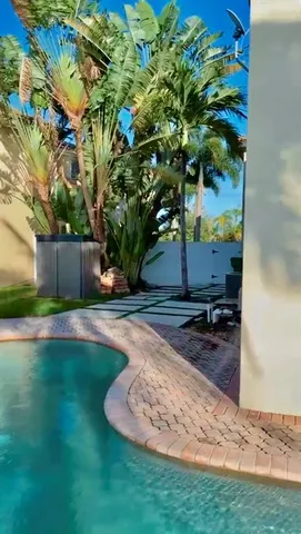 a view of a backyard with plants and patio