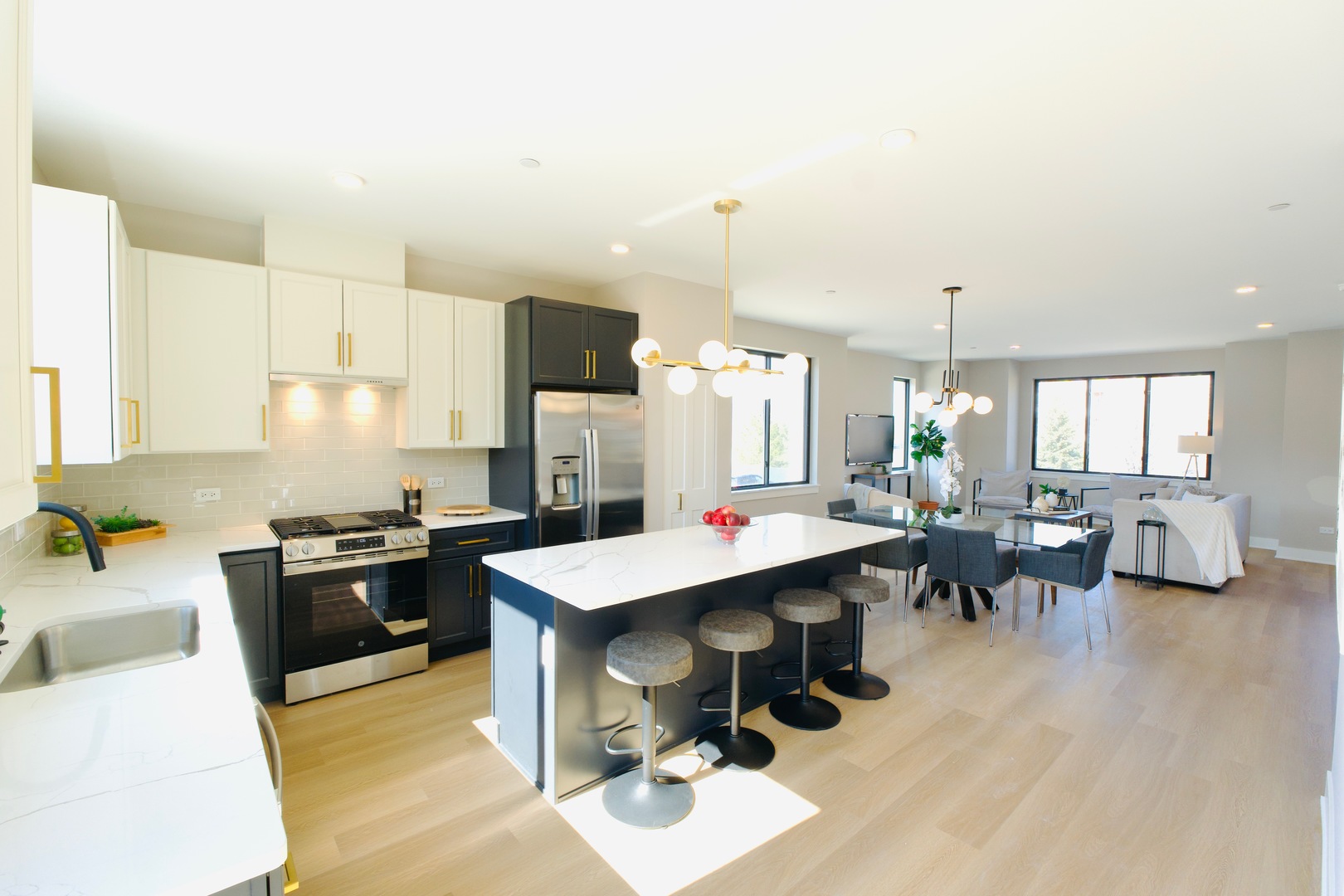a kitchen with kitchen island granite countertop lots of counter top space and stainless steel appliances