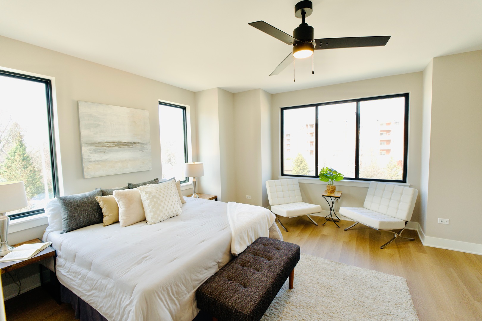 175 Pointe Drive, Unit 175 Northbrook, IL 60062 - Photo 9 of 23 a bedroom with a bed couches and two large window