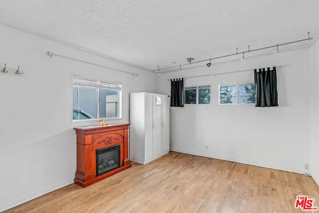 a view of empty room with a fireplace