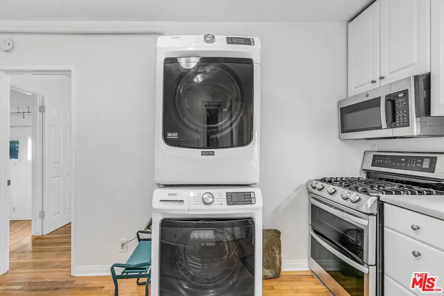 a kitchen with stainless steel appliances a stove and a microwave