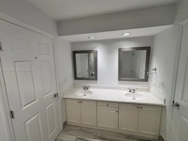 a bathroom with a double vanity sink mirror and