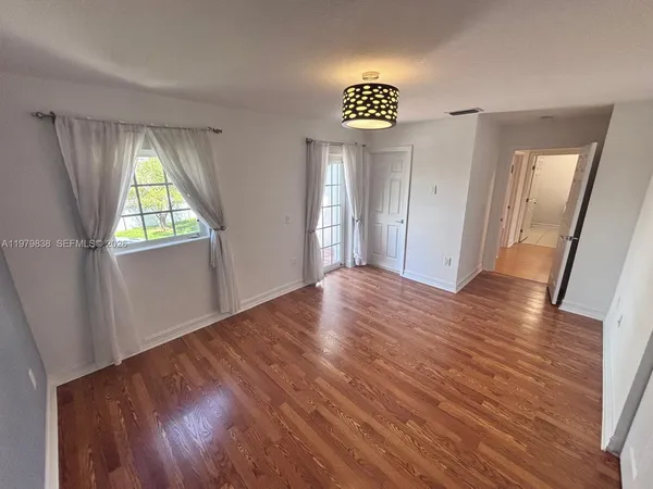 a view of an empty room and wooden floor