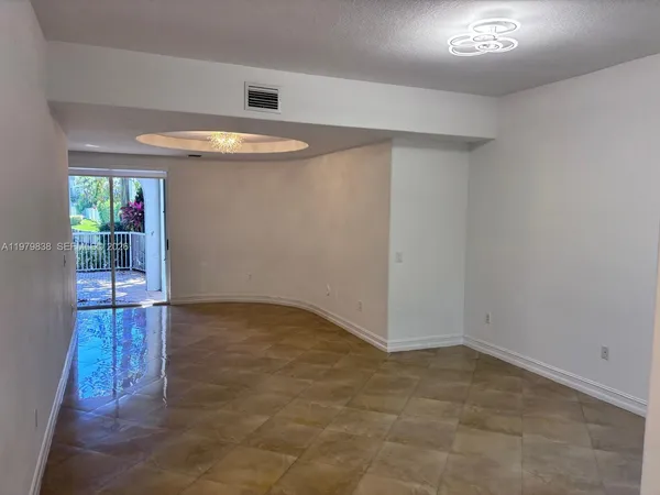 an empty room with windows and entrance