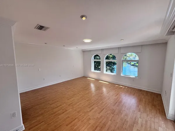 wooden floor in an empty room with window