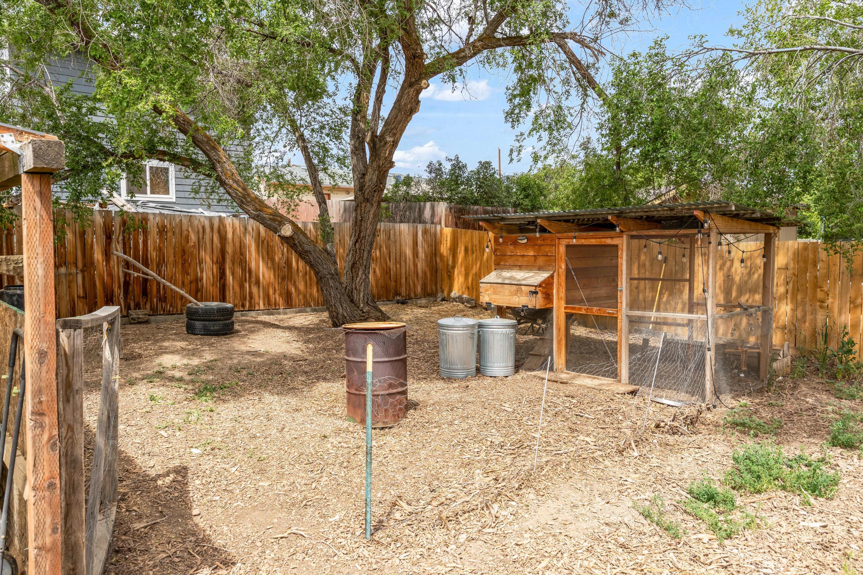 496 Southwest 2nd Street Madras, OR 97741 - Photo 31 of 37 a view of a backyard with wooden fence and a large tree