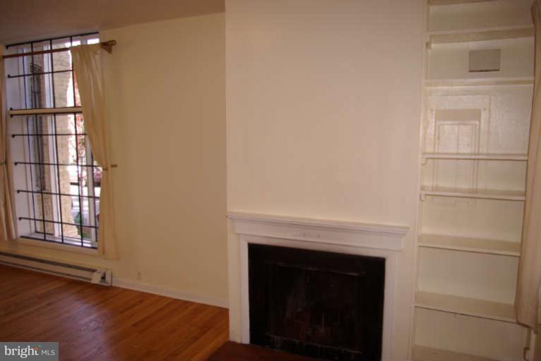 401 E Street Northeast Washington, DC 20002 - Photo 4 of 30 1st flr 1BR unit living area w WBFP and windowwall