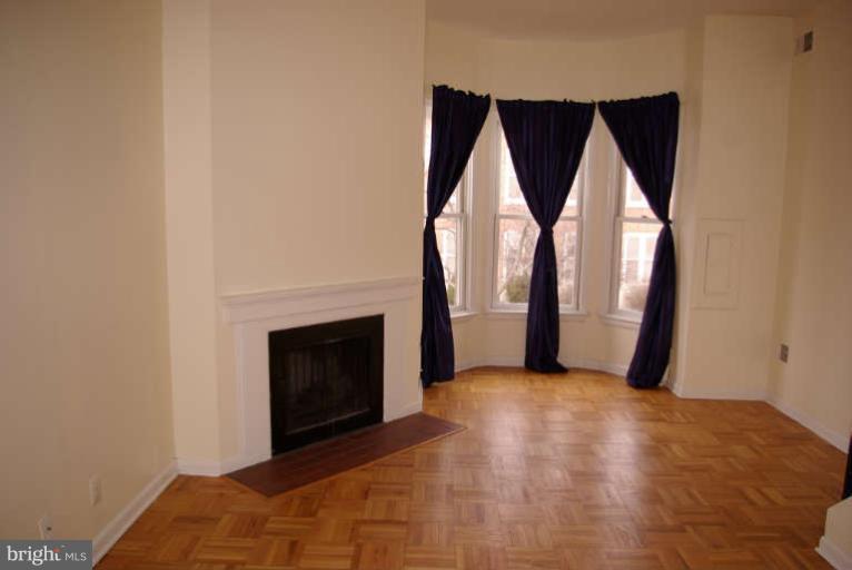 401 E Street Northeast Washington, DC 20002 - Photo 9 of 30 Upstairs unit living area w bay window and WBFP
