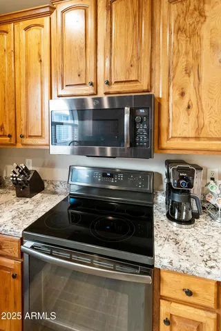 a stove top oven sitting inside of a kitchen