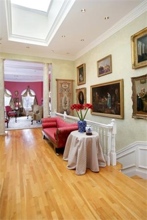 53 Beacon Street, Unit PH Boston, MA 02108 - Photo 2 of 10 a bedroom with furniture and a flat screen tv