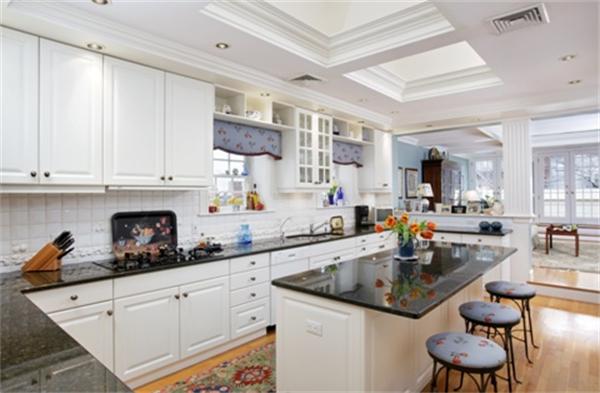 53 Beacon Street, Unit PH Boston, MA 02108 - Photo 5 of 10 a kitchen with stainless steel appliances granite countertop a sink and cabinets