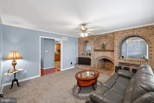 a living room with furniture a lamp and a chandelier
