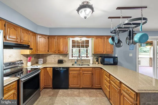 a kitchen with a stove a sink and a refrigerator