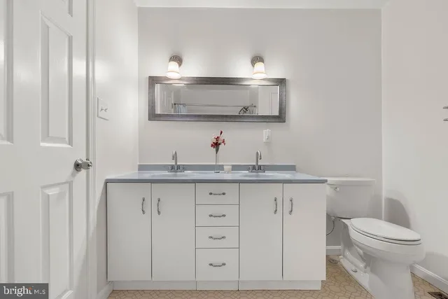a living room with fireplace furniture and a potted plant
