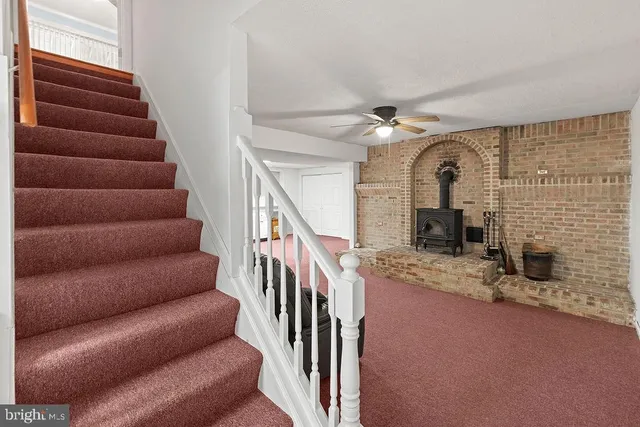 a living room with furniture and stairs