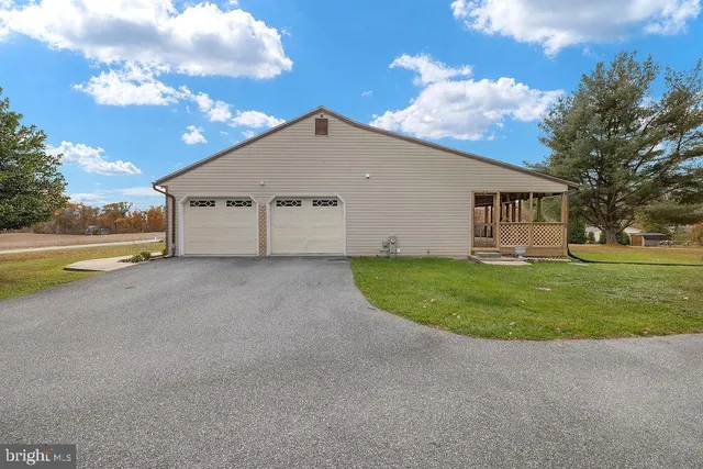 a view of a patio with table and chairs and potted plants