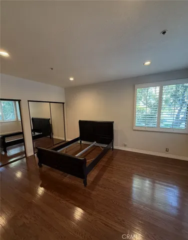 a living room with furniture flat screen tv and wooden floor