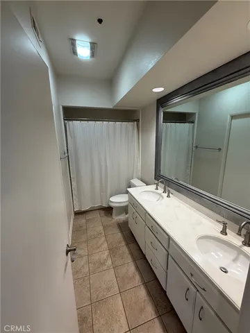 a bathroom with a double vanity sink and a mirror