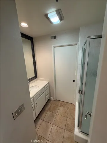 a bathroom with a sink a mirror and a shower