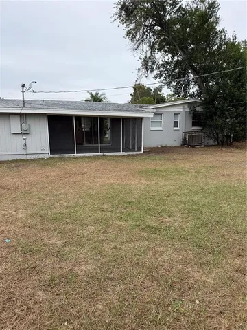 a view of a house with a yard and a garage