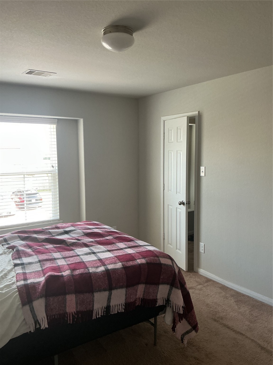 15318 Laceleaf Trail Houston, TX 77044 - Photo 11 of 12 a bedroom with a bed and a window