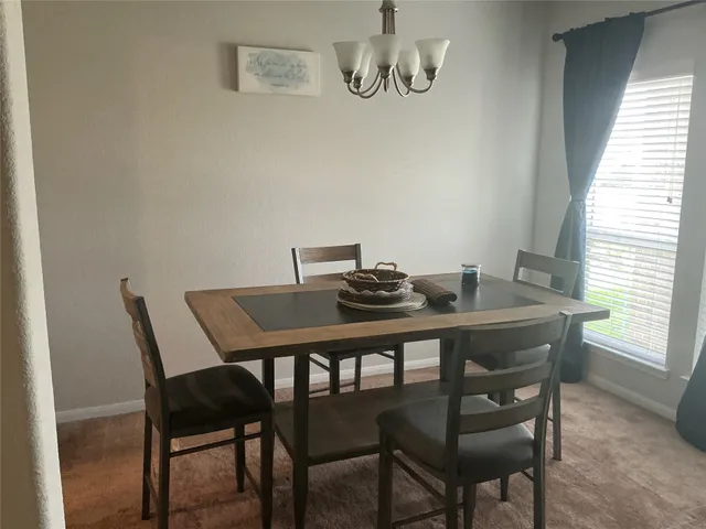 a dining room with a table and chairs