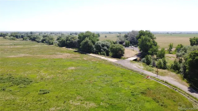 a view of a field with an ocean