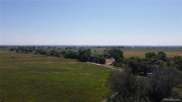 a view of a field with an ocean