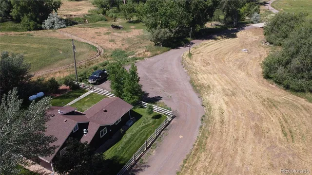 an aerial view of a house with a yard