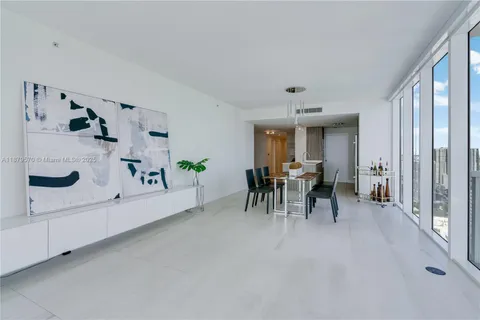 a view of a dining room with furniture and a large window