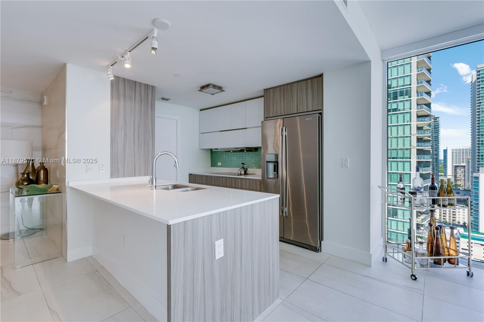 600 Northeast 27th Street, Unit 2801 Miami, FL 33137 - Photo 20 of 48 a kitchen with a sink and refrigerator