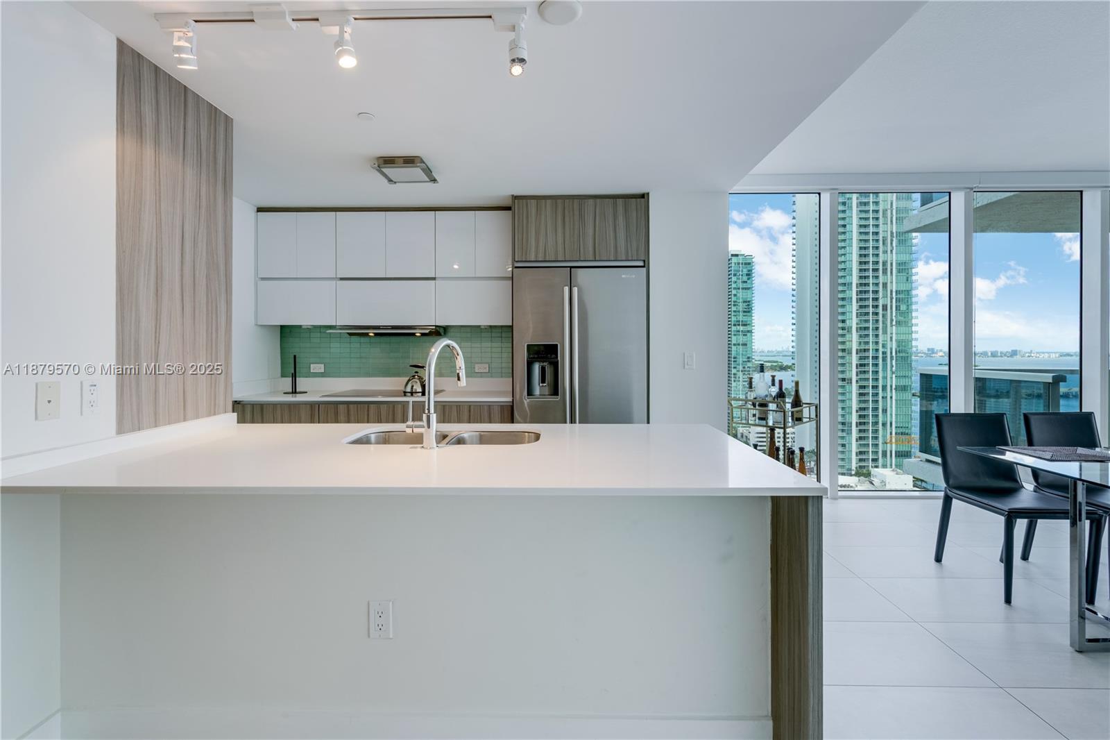 600 Northeast 27th Street, Unit 2801 Miami, FL 33137 - Photo 2 of 48 a room with kitchen island a sink and a large window