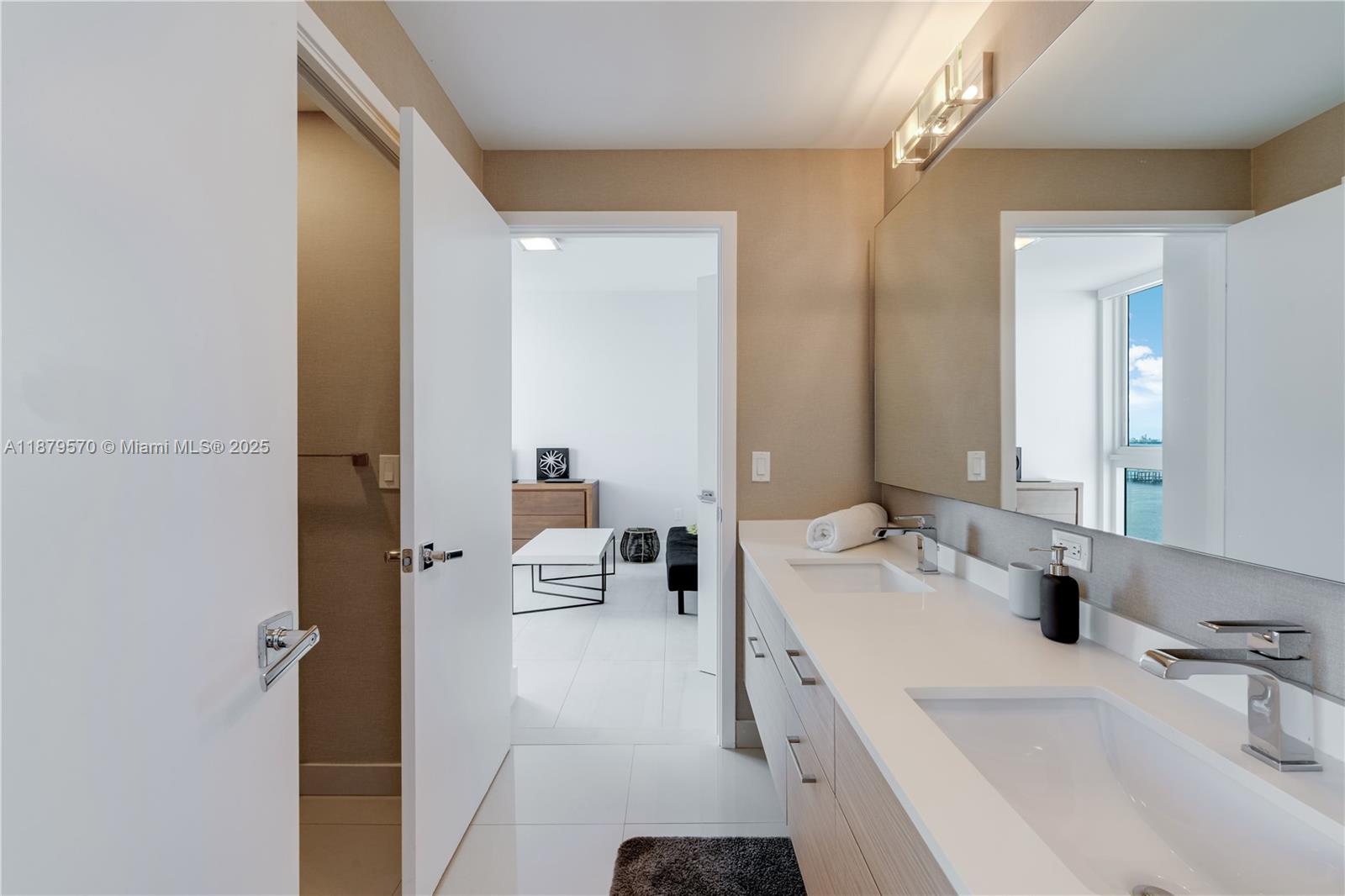 600 Northeast 27th Street, Unit 2801 Miami, FL 33137 - Photo 24 of 48 a bathroom with a double vanity sink and mirror