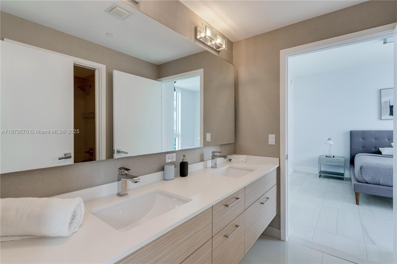 600 Northeast 27th Street, Unit 2801 Miami, FL 33137 - Photo 25 of 48 a bathroom with double vanity sinks and a mirror