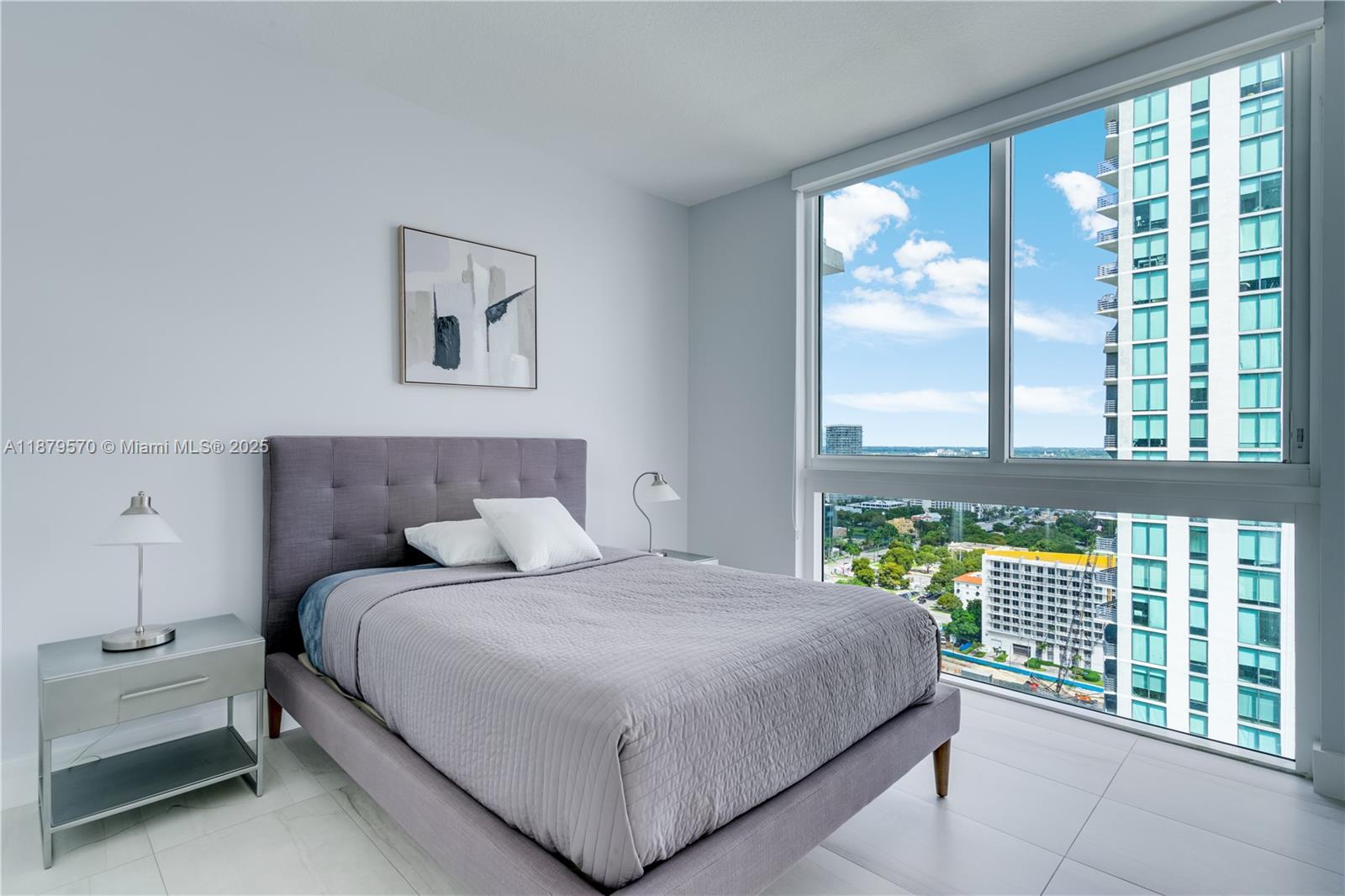 600 Northeast 27th Street, Unit 2801 Miami, FL 33137 - Photo 28 of 48 a bedroom with a large bed and a large window