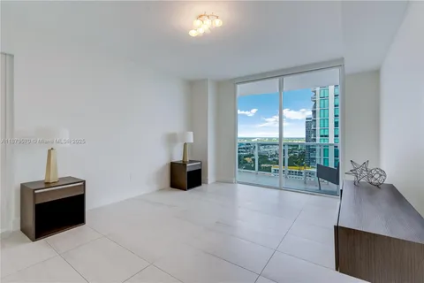 a view of a room with furniture and a window