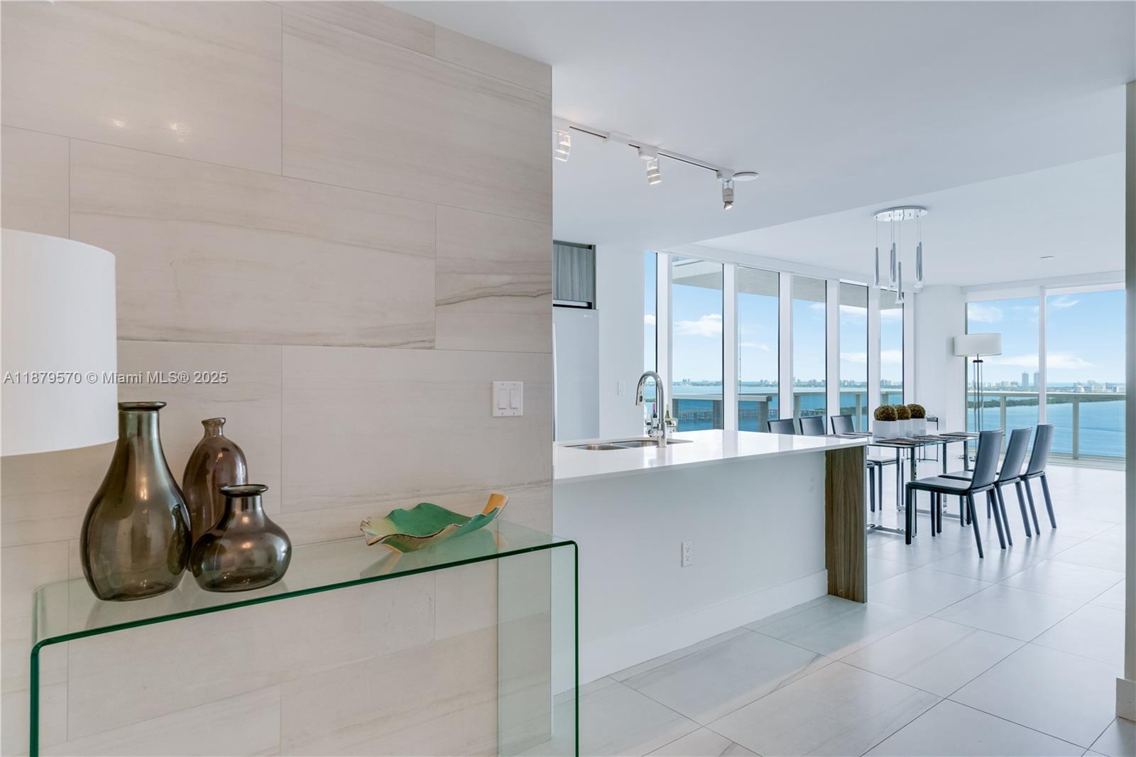 600 Northeast 27th Street, Unit 2801 Miami, FL 33137 - Photo 3 of 48 a kitchen with a table and chairs