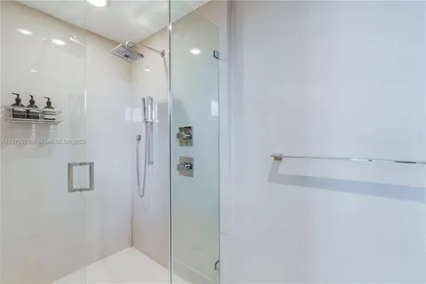 a bathroom with a shower and a glass door
